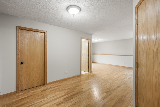 664 Highland Trl, Lino Lakes, MN 55014 - unfurnished room featuring light wood-style floors and a textured ceiling