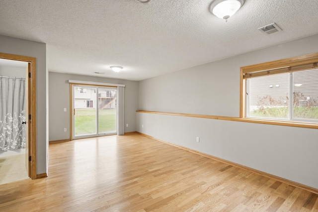 664 Highland Trl, Lino Lakes, MN 55014 - spare room with light wood finished floors and a textured ceiling