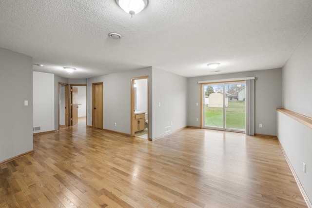 664 Highland Trl, Lino Lakes, MN 55014 - unfurnished room with light wood-style floors and a textured ceiling