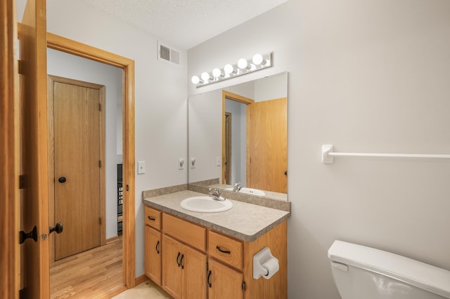 664 Highland Trl, Lino Lakes, MN 55014 - half bathroom with vanity and wood finished floors