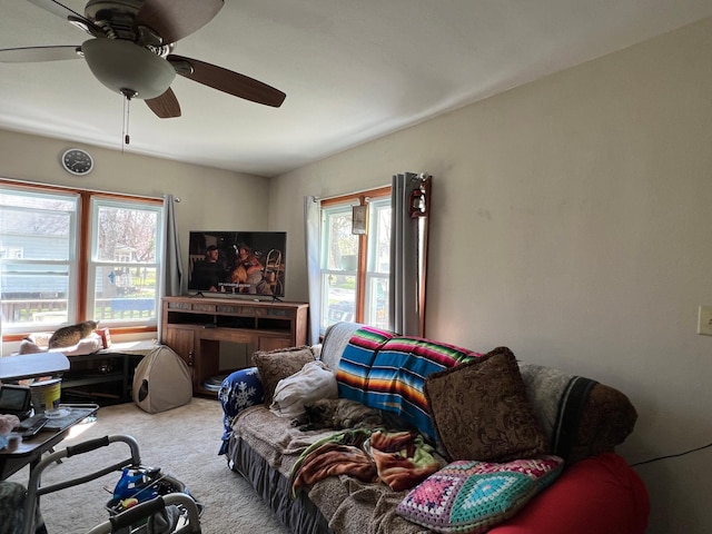 living area featuring carpet and ceiling fan