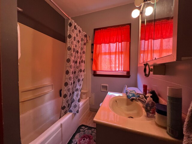 bathroom featuring shower / bath combo and vanity
