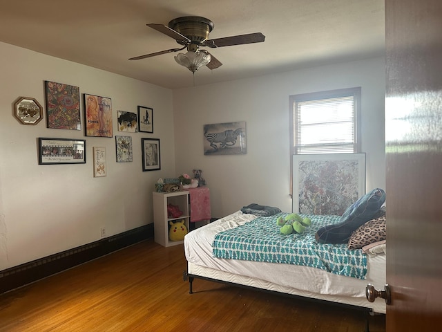 bedroom with a ceiling fan and wood finished floors