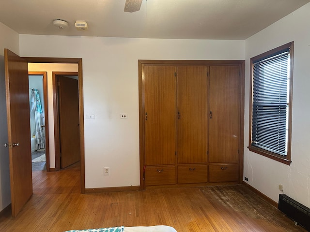 unfurnished bedroom with a closet, visible vents, baseboards, and light wood-type flooring