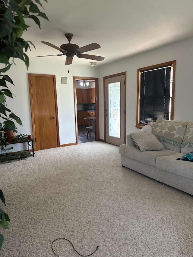 living room with a ceiling fan and carpet flooring