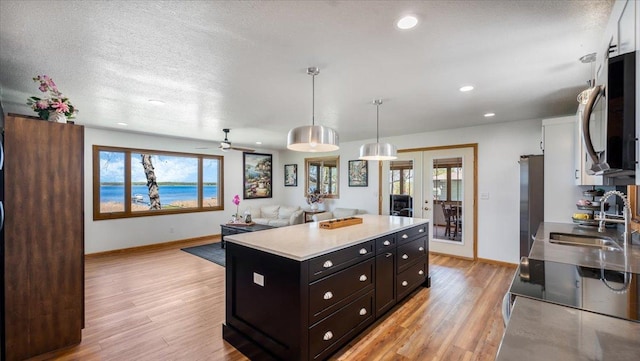 7355 Little Mary Cir SW, Alexandria, MN 56308 - kitchen with a sink, light wood-style flooring, baseboards, range with electric cooktop, and french doors
