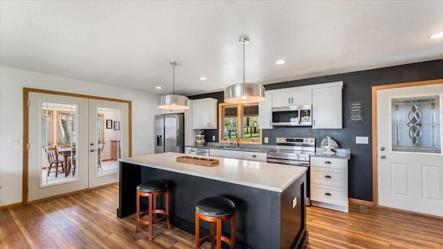 7355 Little Mary Cir SW, Alexandria, MN 56308 - kitchen featuring appliances with stainless steel finishes, a sink, french doors, light wood-type flooring, and recessed lighting