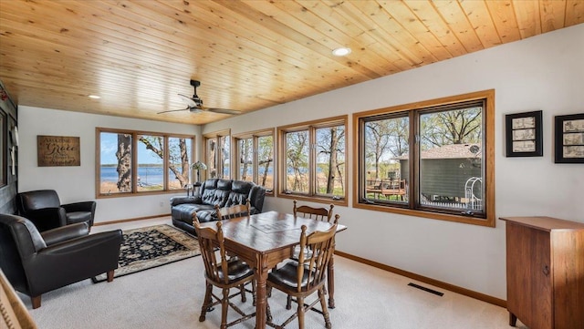 7355 Little Mary Cir SW, Alexandria, MN 56308 - dining space with light carpet, baseboards, ceiling fan, and wooden ceiling