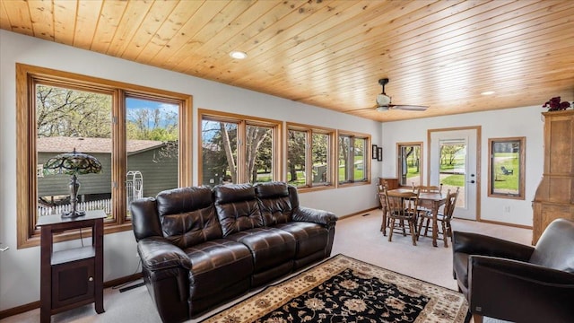 7355 Little Mary Cir SW, Alexandria, MN 56308 - living room featuring baseboards, light colored carpet, plenty of natural light, wooden ceiling, and a ceiling fan