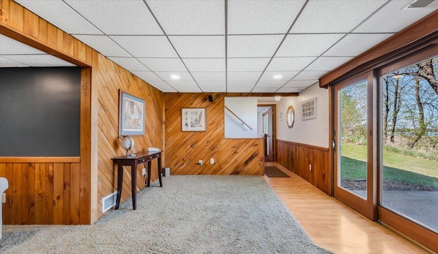 7355 Little Mary Cir SW, Alexandria, MN 56308 - unfurnished room featuring wood walls, a drop ceiling, a wainscoted wall, recessed lighting, and wood finished floors