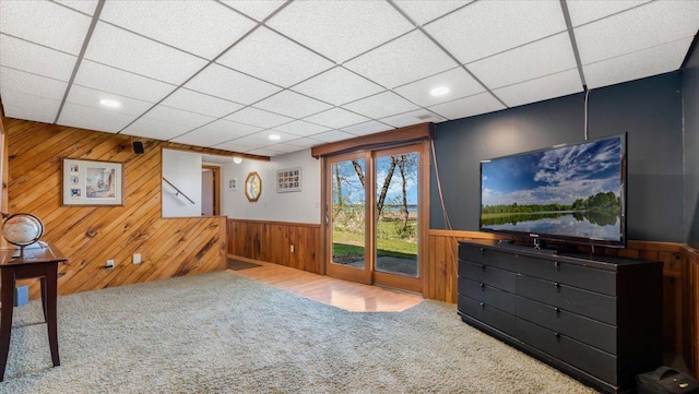 7355 Little Mary Cir SW, Alexandria, MN 56308 - unfurnished living room with carpet flooring, wooden walls, wainscoting, a drop ceiling, and recessed lighting