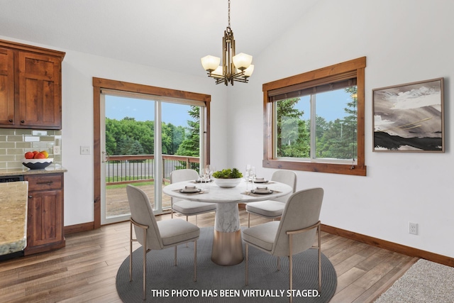116 Wheat Field Ln, New Richmond, WI 54017 - dining area featuring a chandelier, healthy amount of natural light, light wood-type flooring, and vaulted ceiling