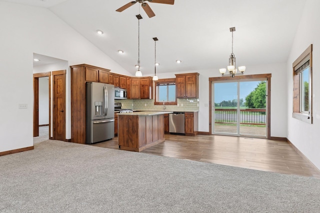 116 Wheat Field Ln, New Richmond, WI 54017 - kitchen featuring stainless steel appliances, a ceiling fan, carpet flooring, open floor plan, and light countertops