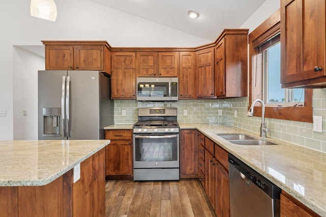 116 Wheat Field Ln, New Richmond, WI 54017 - kitchen with stainless steel appliances, lofted ceiling, wood finished floors, light stone counters, and backsplash