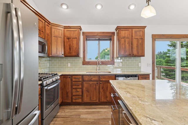 116 Wheat Field Ln, New Richmond, WI 54017 - kitchen with appliances with stainless steel finishes, plenty of natural light, light wood finished floors, light stone countertops, and recessed lighting
