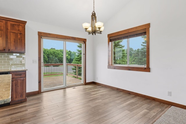 116 Wheat Field Ln, New Richmond, WI 54017 - unfurnished dining area featuring a chandelier, healthy amount of natural light, light wood-style floors, and lofted ceiling