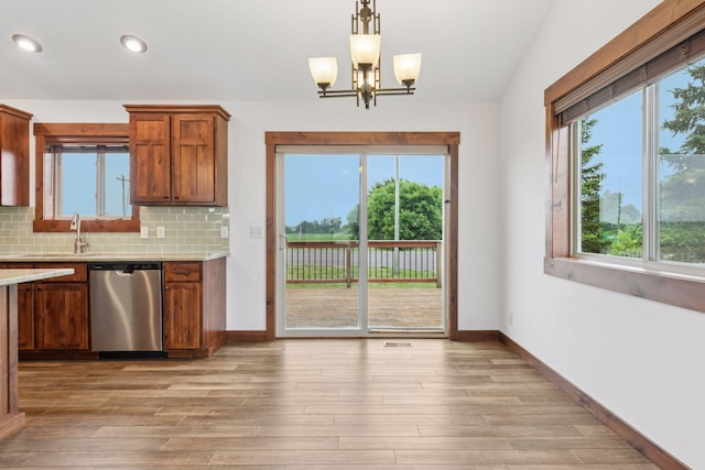 116 Wheat Field Ln, New Richmond, WI 54017 - kitchen featuring dishwasher, a chandelier, light wood finished floors, decorative backsplash, and recessed lighting
