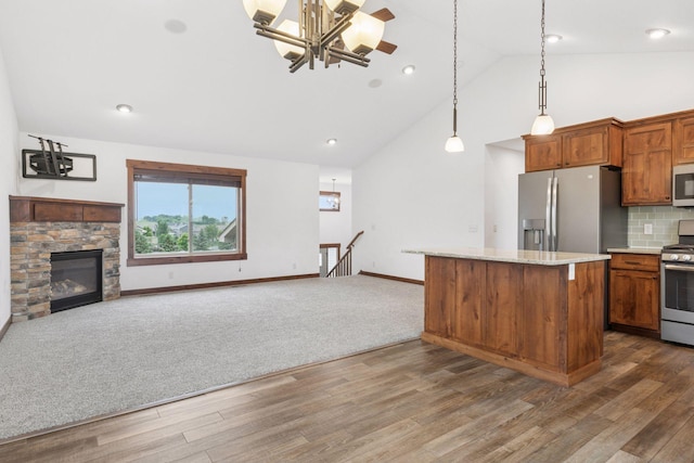 116 Wheat Field Ln, New Richmond, WI 54017 - kitchen with stainless steel appliances, dark wood-type flooring, open floor plan, and high vaulted ceiling