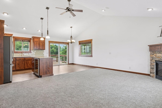 116 Wheat Field Ln, New Richmond, WI 54017 - kitchen featuring open floor plan, carpet floors, wine cooler, freestanding refrigerator, and a fireplace
