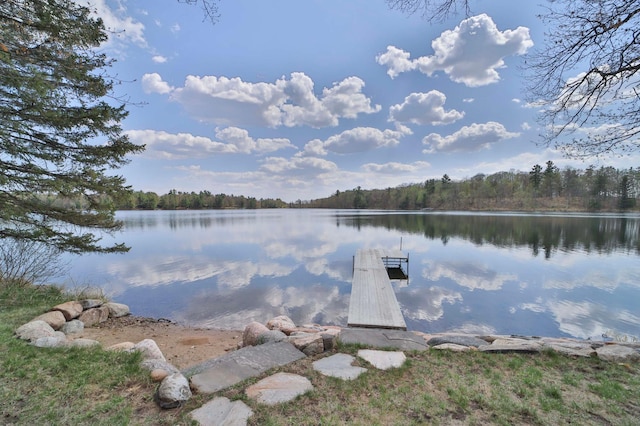 dock area featuring a water view and a wooded view