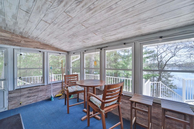 sunroom featuring lofted ceiling and plenty of natural light
