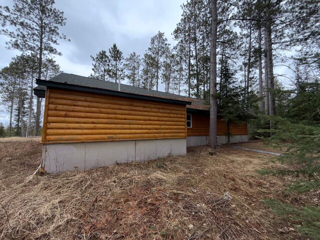 52325 County Road 31, Wirt, MN 56688 - view of side of property with a shingled roof and log veneer siding