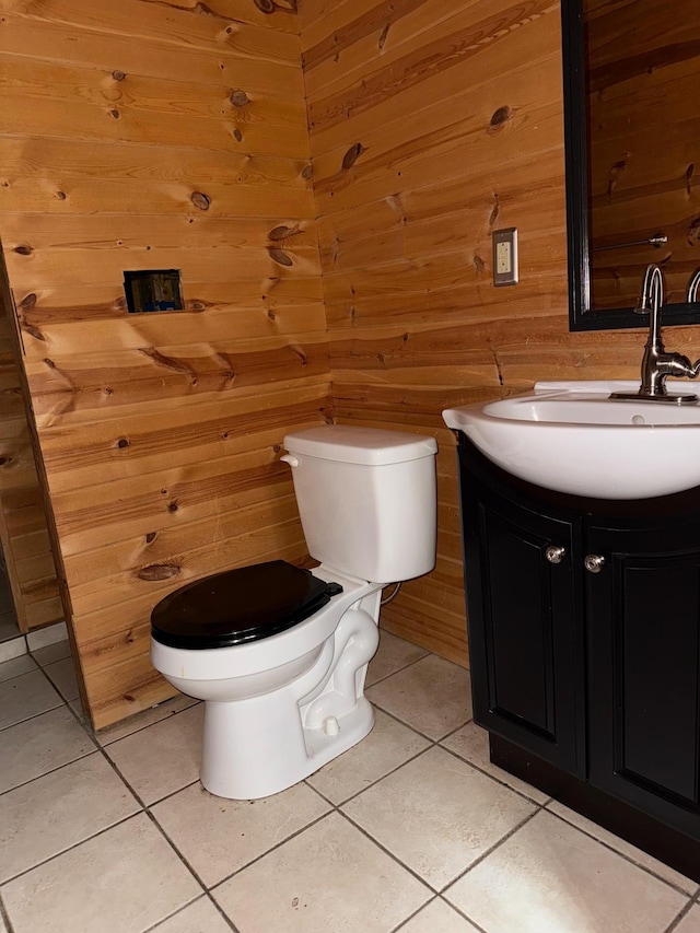 52325 County Road 31, Wirt, MN 56688 - bathroom featuring wooden walls, toilet, tile patterned floors, and vanity