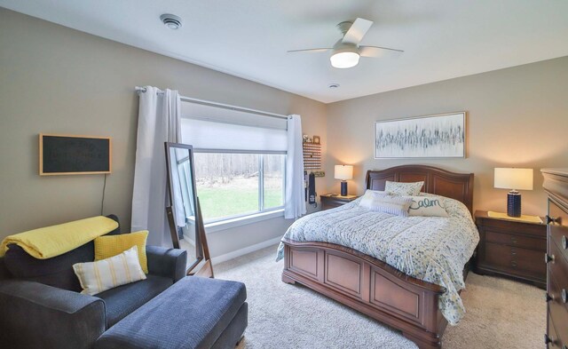 bedroom featuring baseboards, ceiling fan, and light colored carpet