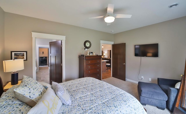carpeted bedroom featuring a ceiling fan, baseboards, and visible vents