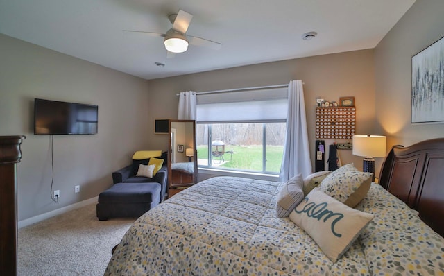 carpeted bedroom with baseboards and a ceiling fan