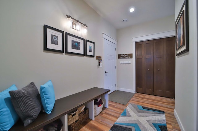 mudroom featuring recessed lighting, baseboards, and light wood finished floors