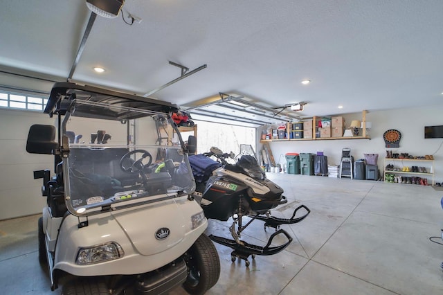 garage featuring a garage door opener and recessed lighting
