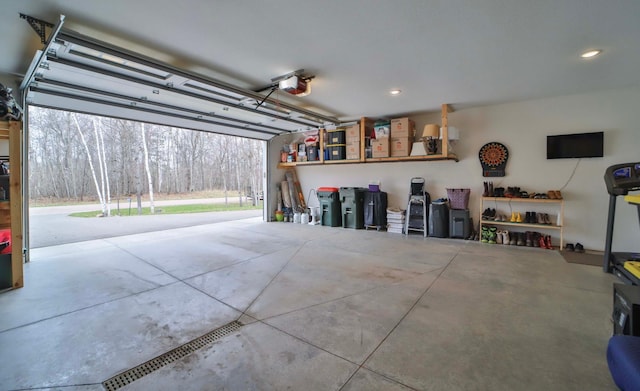 garage featuring recessed lighting and a garage door opener