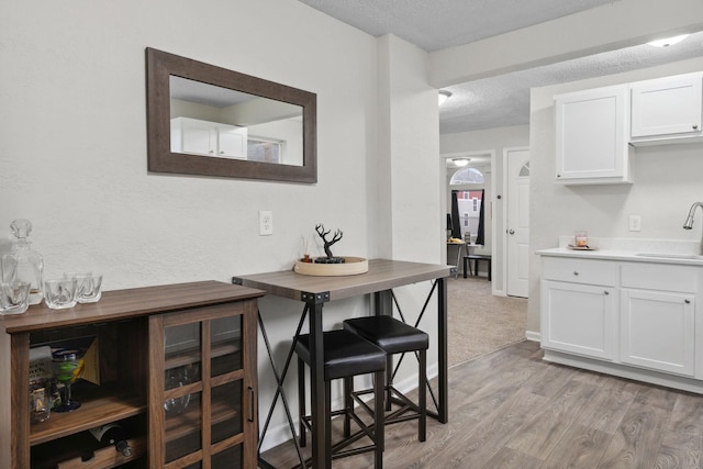interior space with a textured ceiling and light wood-style floors