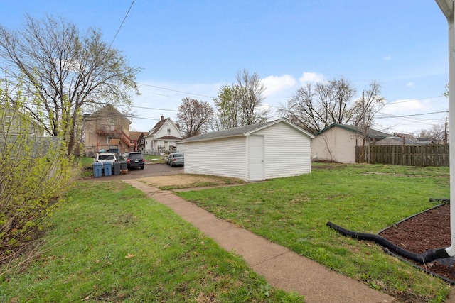 view of yard featuring fence and an outdoor structure