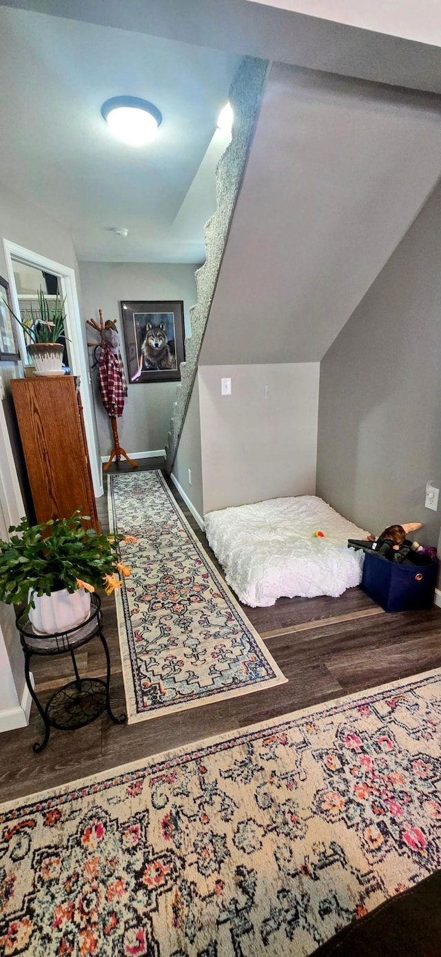 interior space featuring baseboards and wood finished floors