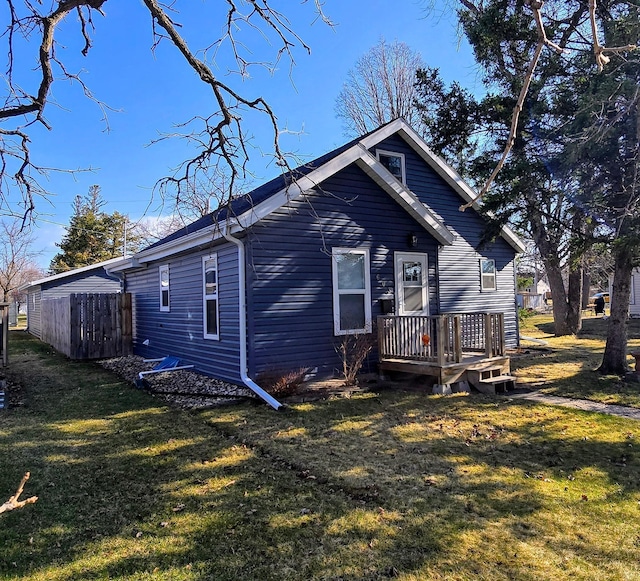 exterior space with a lawn and fence