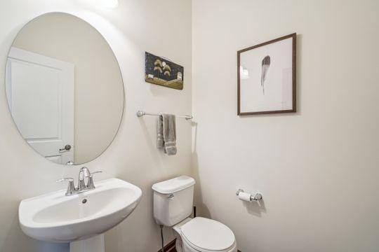 bathroom featuring toilet and a sink