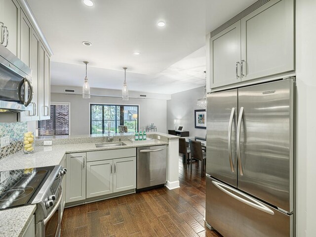1235 Yale Pl Unit 101, Minneapolis, MN 55403 - kitchen with recessed lighting, a sink, stainless steel appliances, a peninsula, and dark wood finished floors