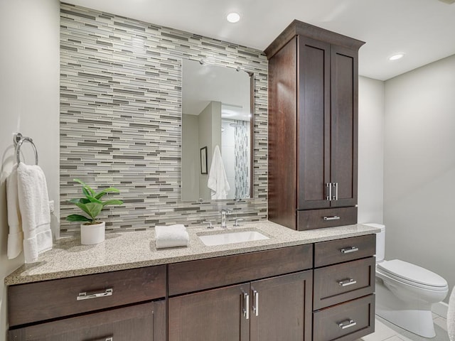 1235 Yale Pl Unit 101, Minneapolis, MN 55403 - bathroom featuring tasteful backsplash, vanity, toilet, and tile patterned flooring