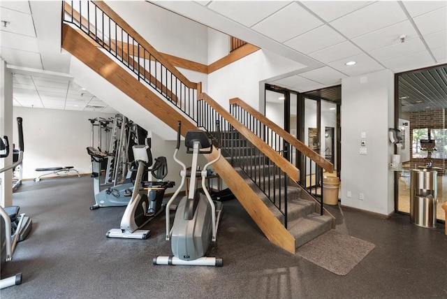 1235 Yale Pl Unit 101, Minneapolis, MN 55403 - stairs featuring a paneled ceiling and baseboards