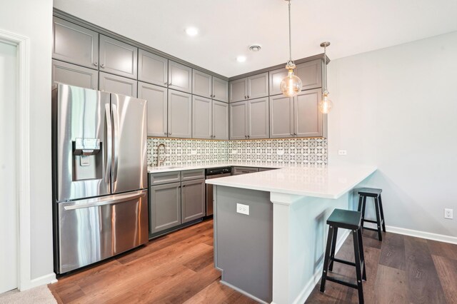 11504 Yuma Ln N, Dayton, MN 55369 - kitchen featuring stainless steel appliances, gray cabinets, a peninsula, a sink, and a breakfast bar area