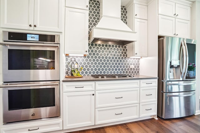 11504 Yuma Ln N, Dayton, MN 55369 - kitchen featuring appliances with stainless steel finishes, custom range hood, white cabinetry, and backsplash