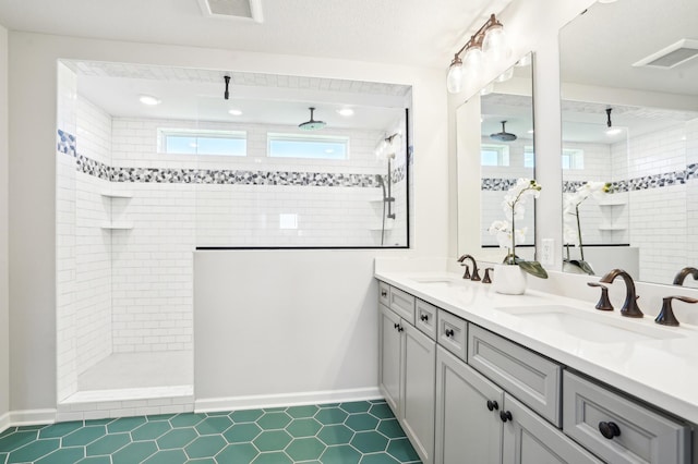 11504 Yuma Ln N, Dayton, MN 55369 - bathroom featuring walk in shower, tile patterned flooring, baseboards, double vanity, and recessed lighting