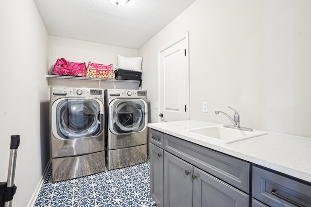 11504 Yuma Ln N, Dayton, MN 55369 - washroom with washing machine and dryer, cabinet space, a textured ceiling, and baseboards