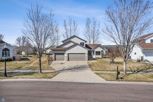 view of front of house with an attached garage, a front yard, and concrete driveway