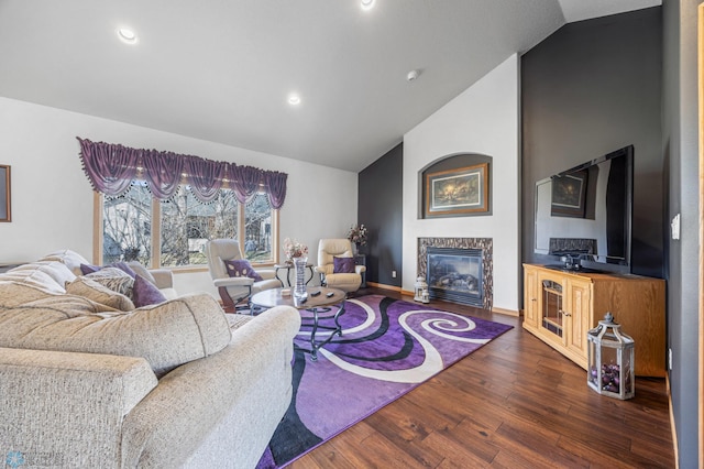 living area featuring wood finished floors, a fireplace, baseboards, high vaulted ceiling, and recessed lighting