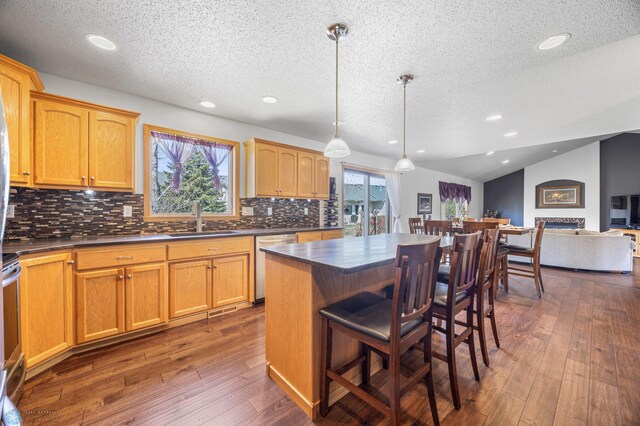 kitchen with a textured ceiling, dark countertops, and stainless steel appliances