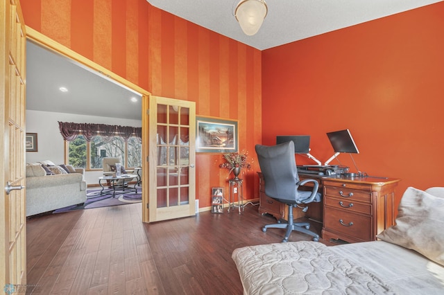 home office with baseboards, wood-type flooring, french doors, and wallpapered walls