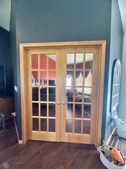 interior details featuring baseboards, french doors, and wood finished floors